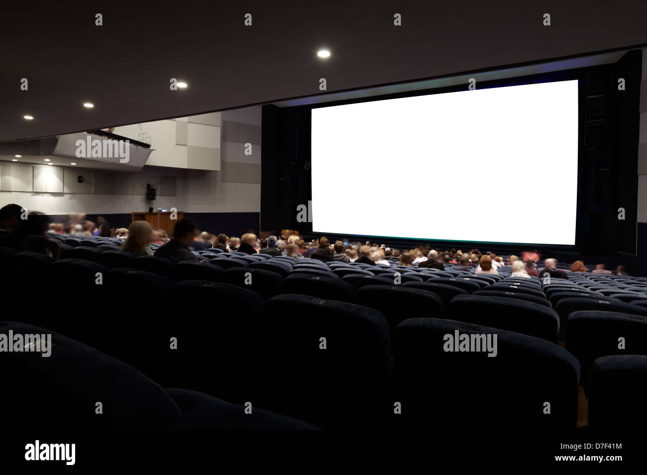 Cinema auditorium with people in chairs watching movie. Ready for