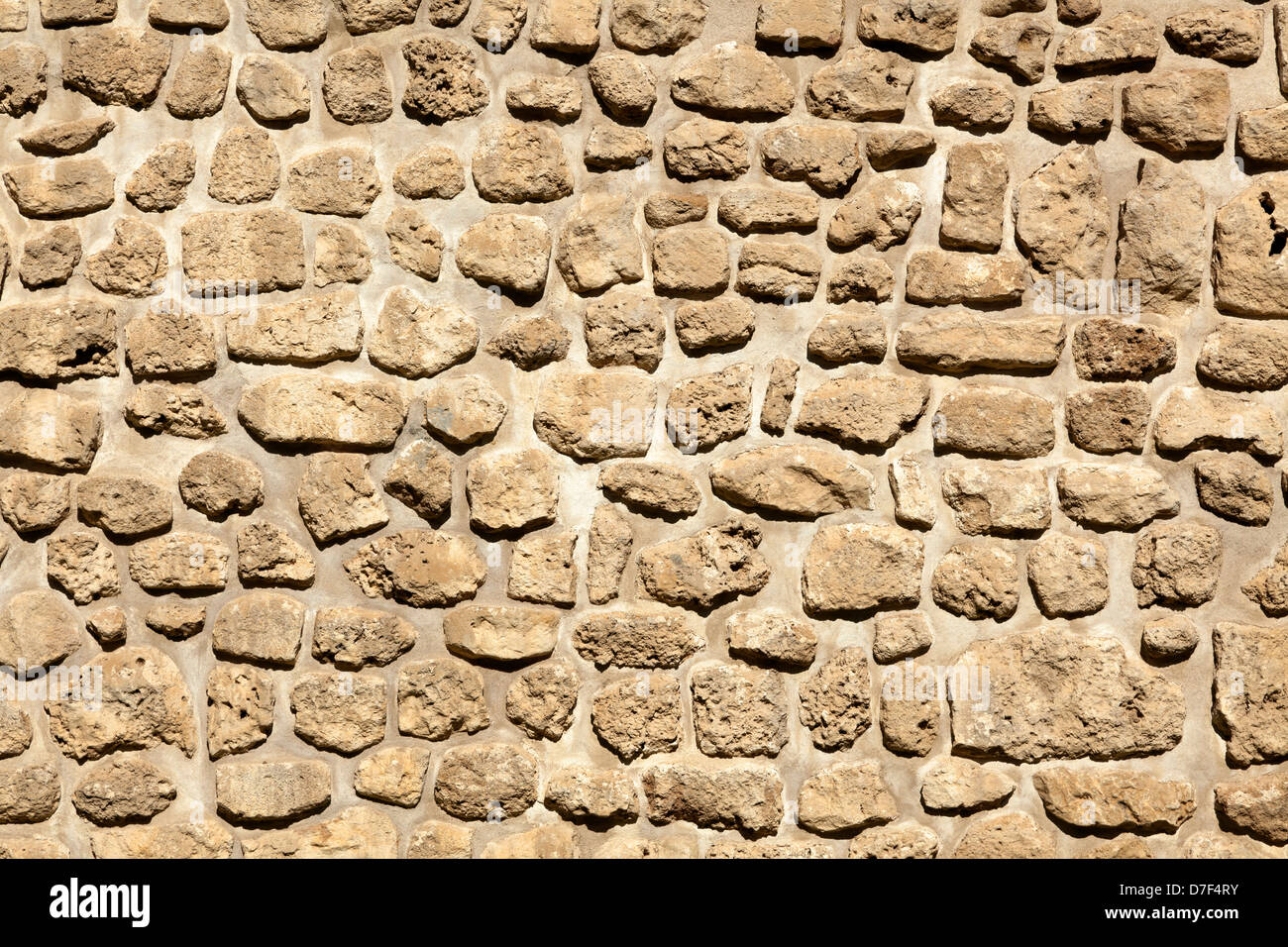 Stone wall in the sunlight. Stock Photo