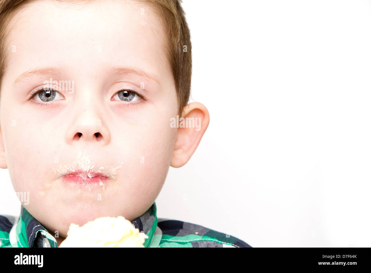 Small boy eating a cake Stock Photo