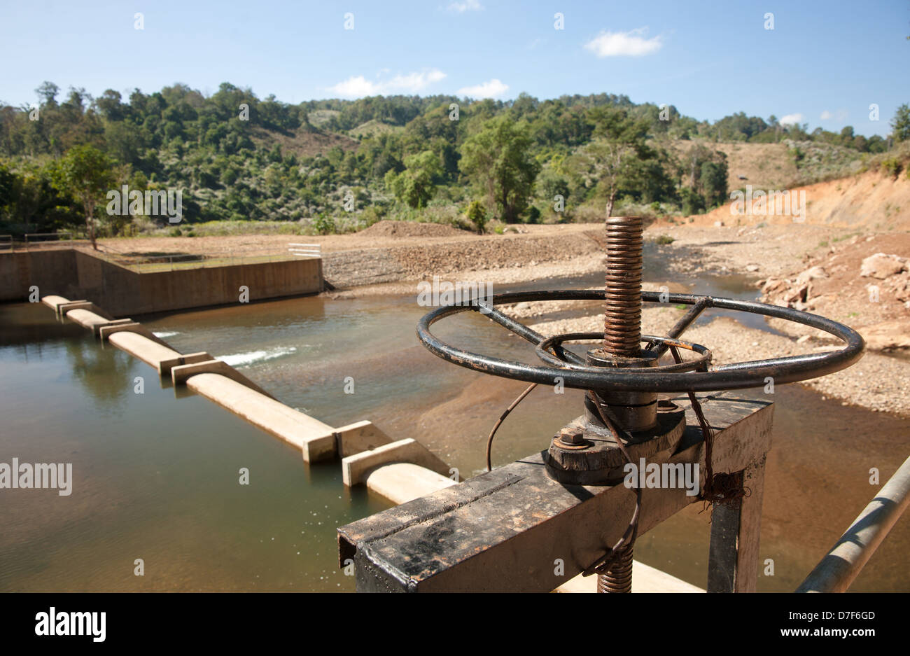 release wheel on small dam in northern thailand Stock Photo