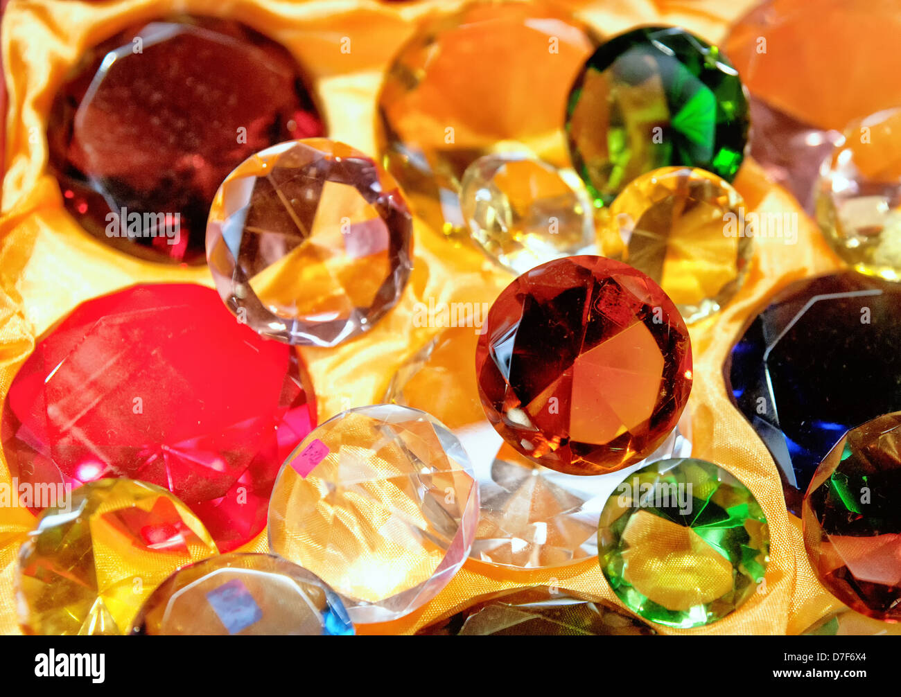 glass gems on yellow fabric for sale Stock Photo