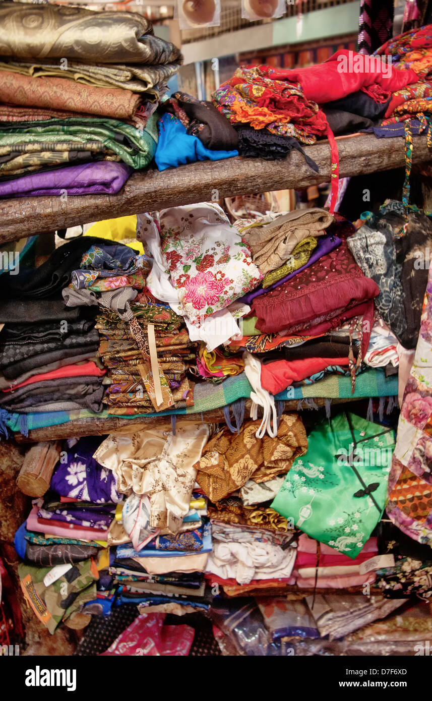 very rough pile of clothing on shop shelf in chinatown kl malaysia Stock Photo