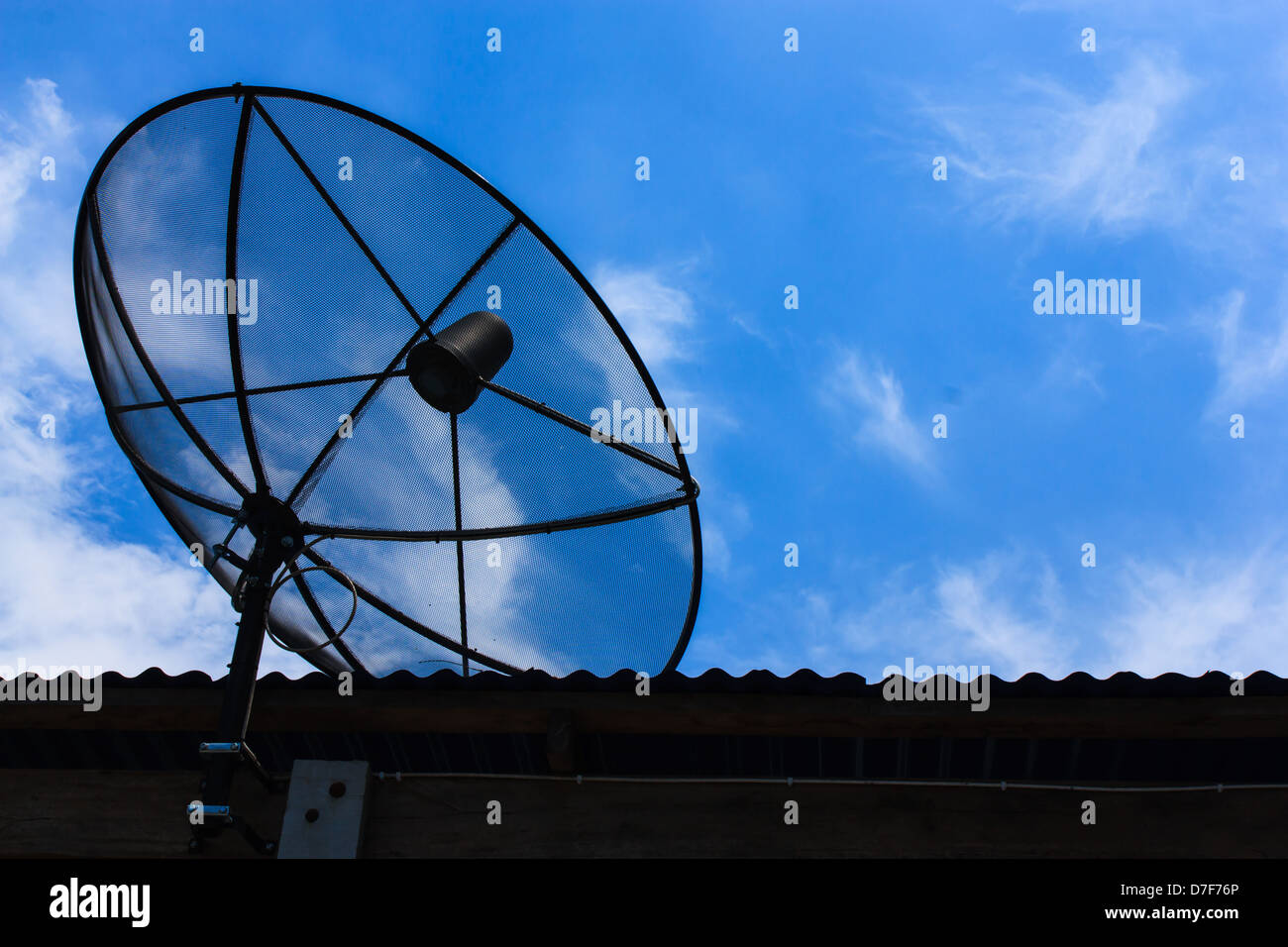 satellite dish on the top roof with blue sky in the sunrise day Stock Photo