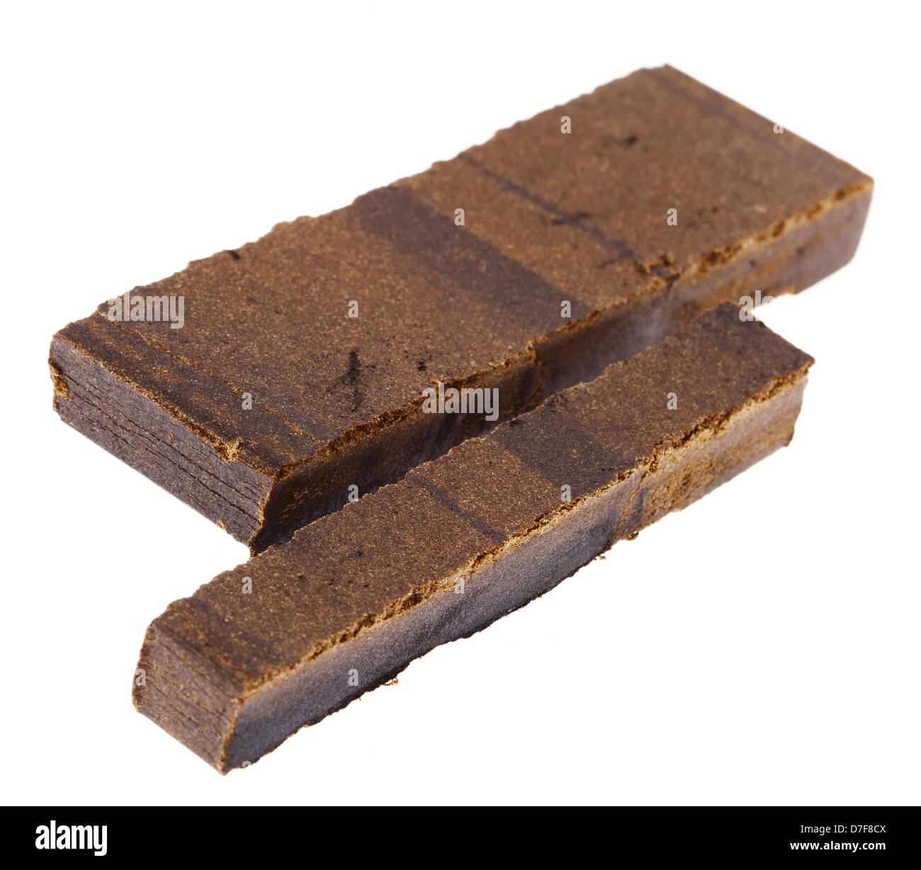 A 10 grams piece Hashish laid next to 20 grams piece isolated on white background. This pieces represent quantity three retail Stock Photo