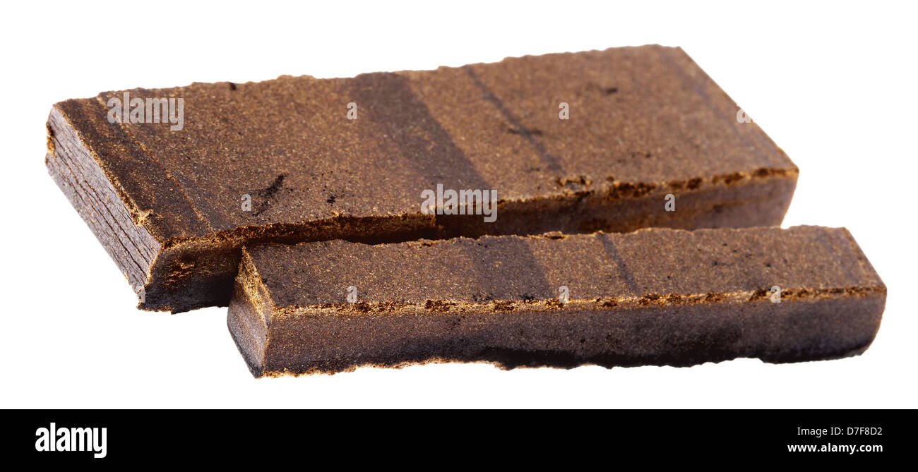 A 10 grams piece Hashish laid next to 20 grams piece isolated on white background. This pieces represent quantity three retail Stock Photo
