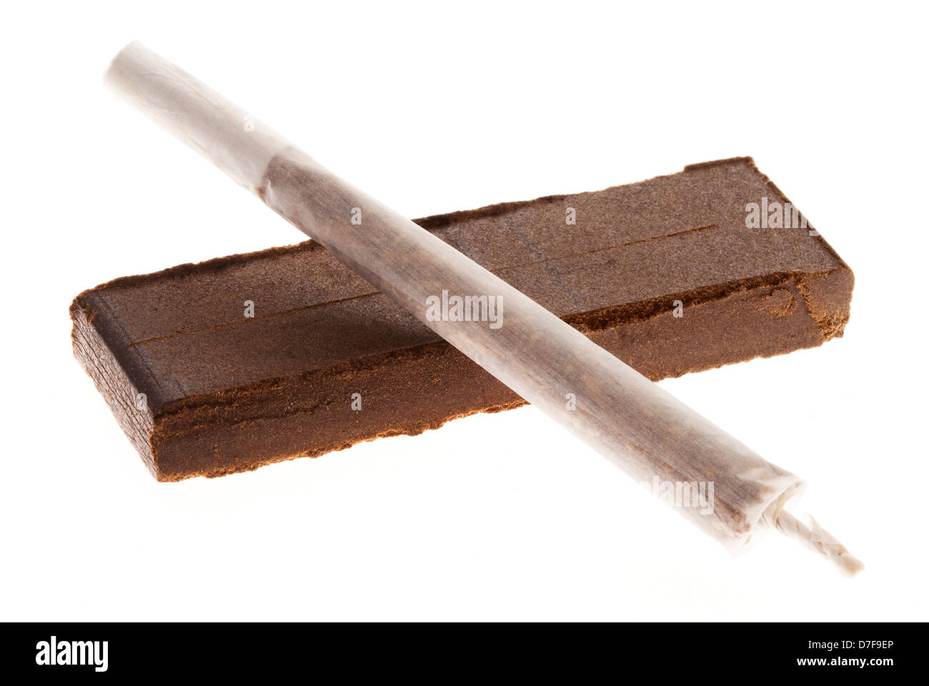 An unlit joint laid on 20 grams piece Hashish isolated on white background. This piece represents shape weight double retail Stock Photo