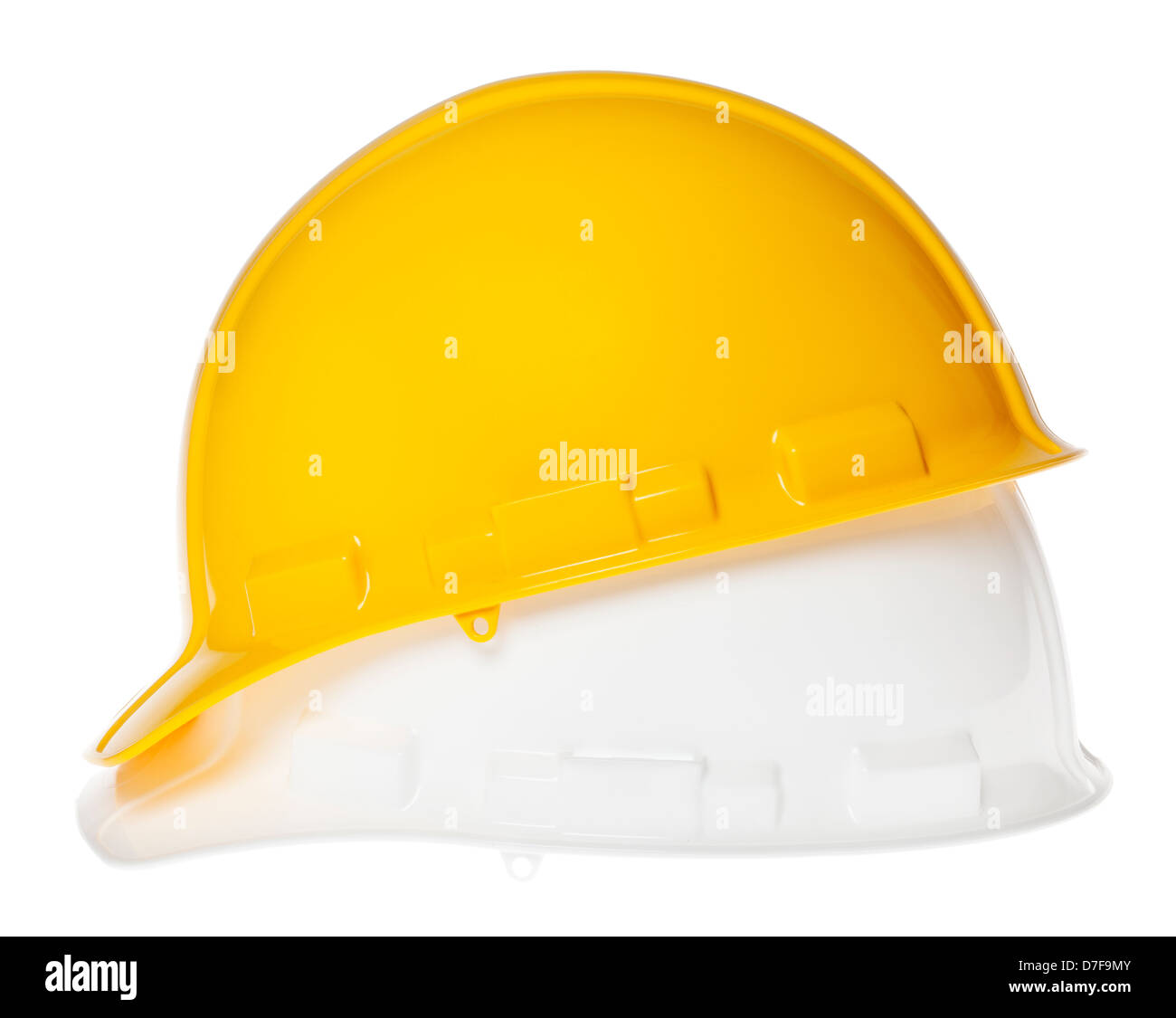 Side view of two hard hats, yellow on top of white, isolated on white