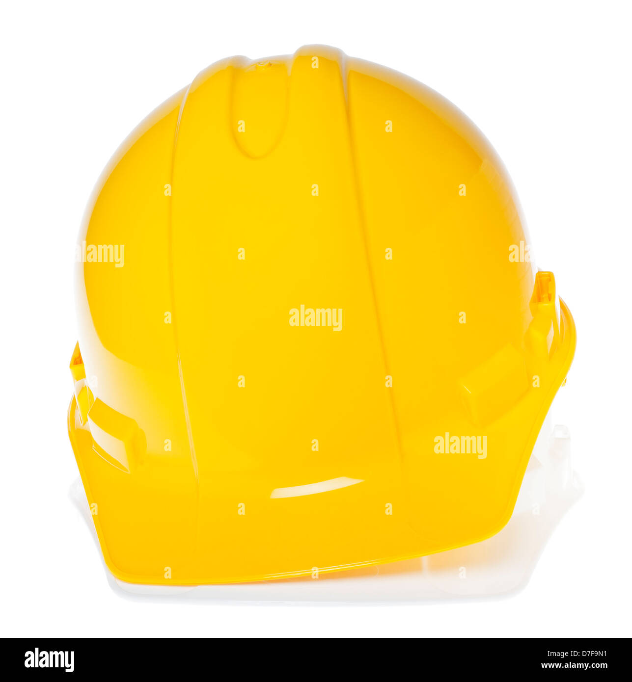 Frontal view of two hard hats, yellow on top of white, isolated on white background. Stock Photo