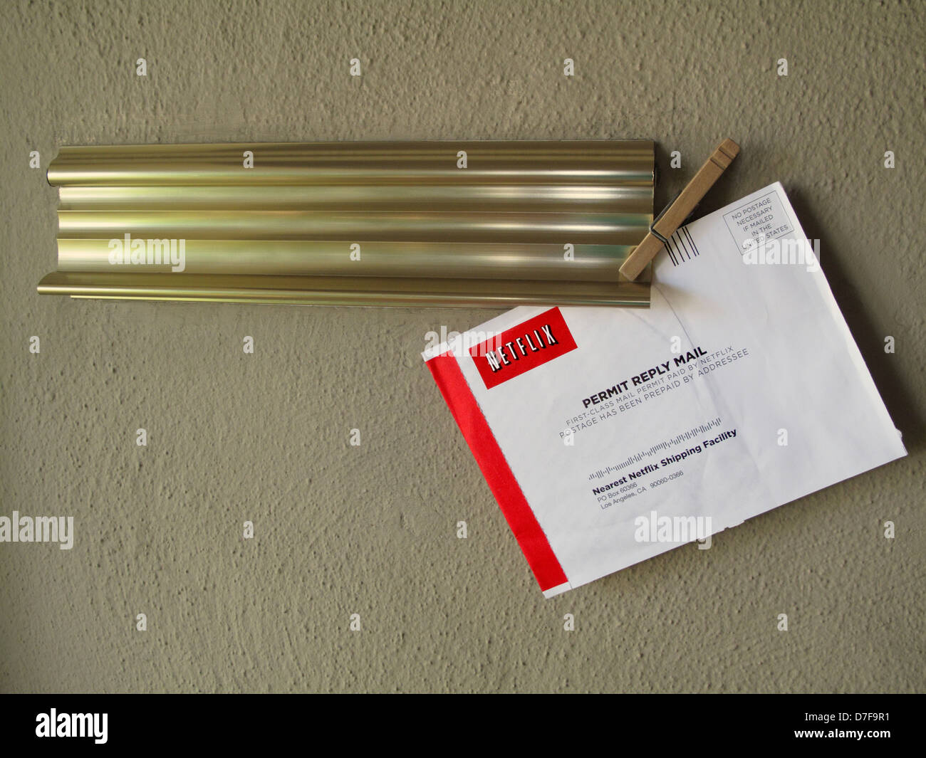 Netflix DVD mailer clipped to mail slot with clothes pin Stock Photo
