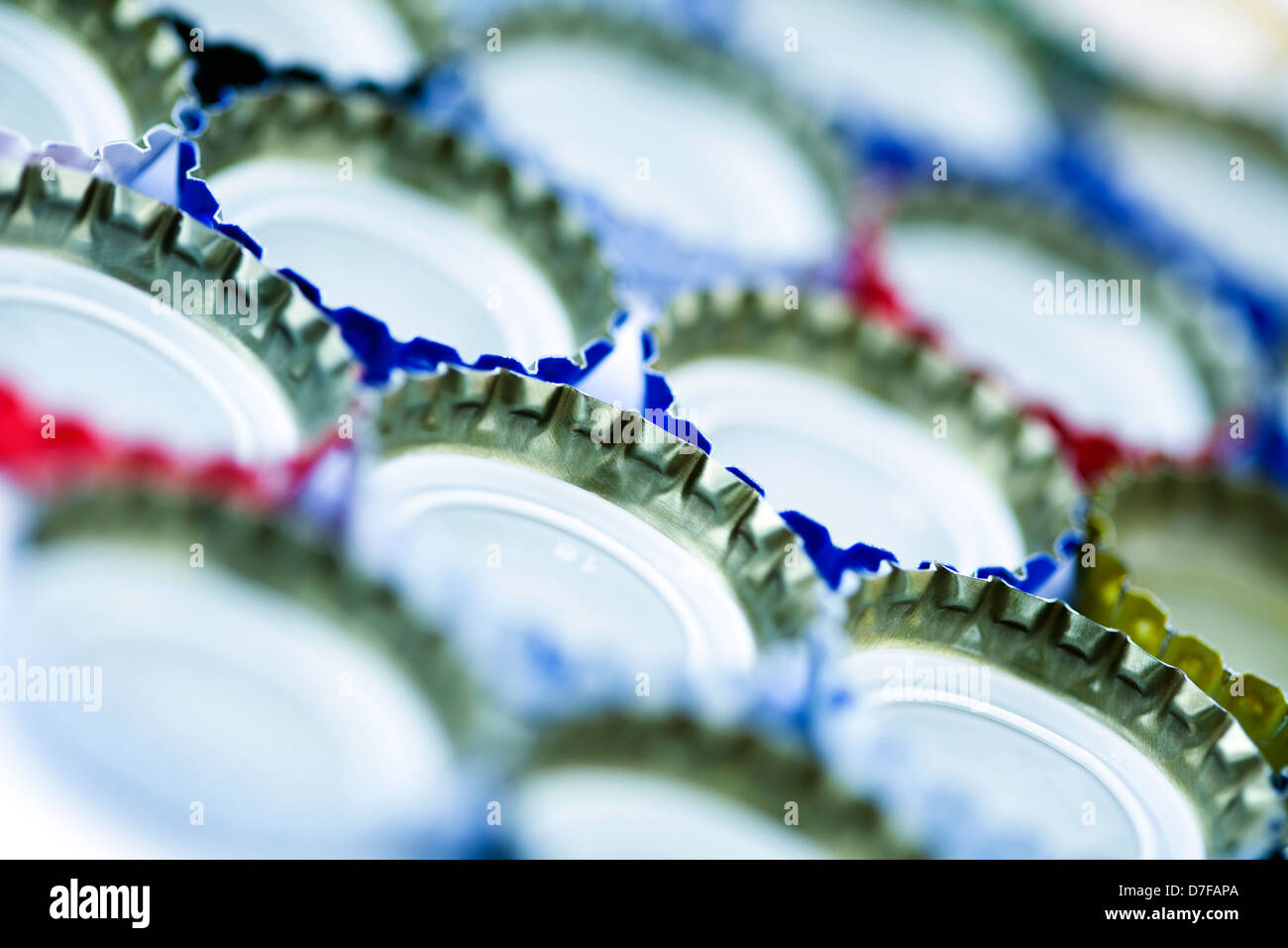 Five rows of metal bottle caps aligned upside down and diagonally to