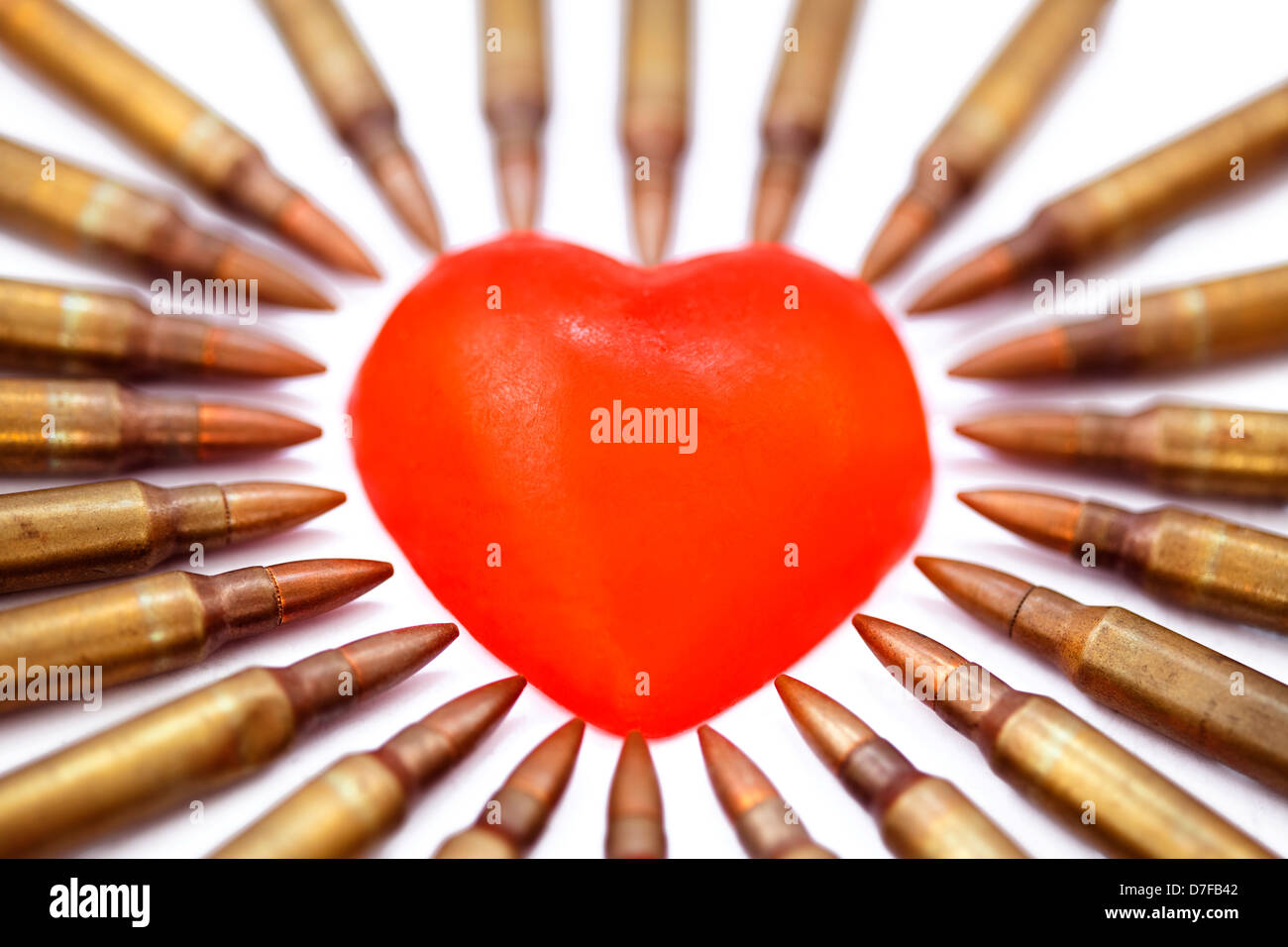 A heart shaped bar soap is surrounded by 5.56 cartridges pointing at it.  Fits concept 'Heart Attack'. Very shallow depth field Stock Photo - Alamy