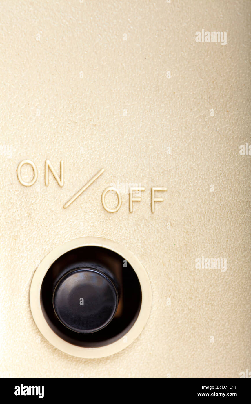 A black plastic button with the writing 'ON / OFF' above it, amongst ...