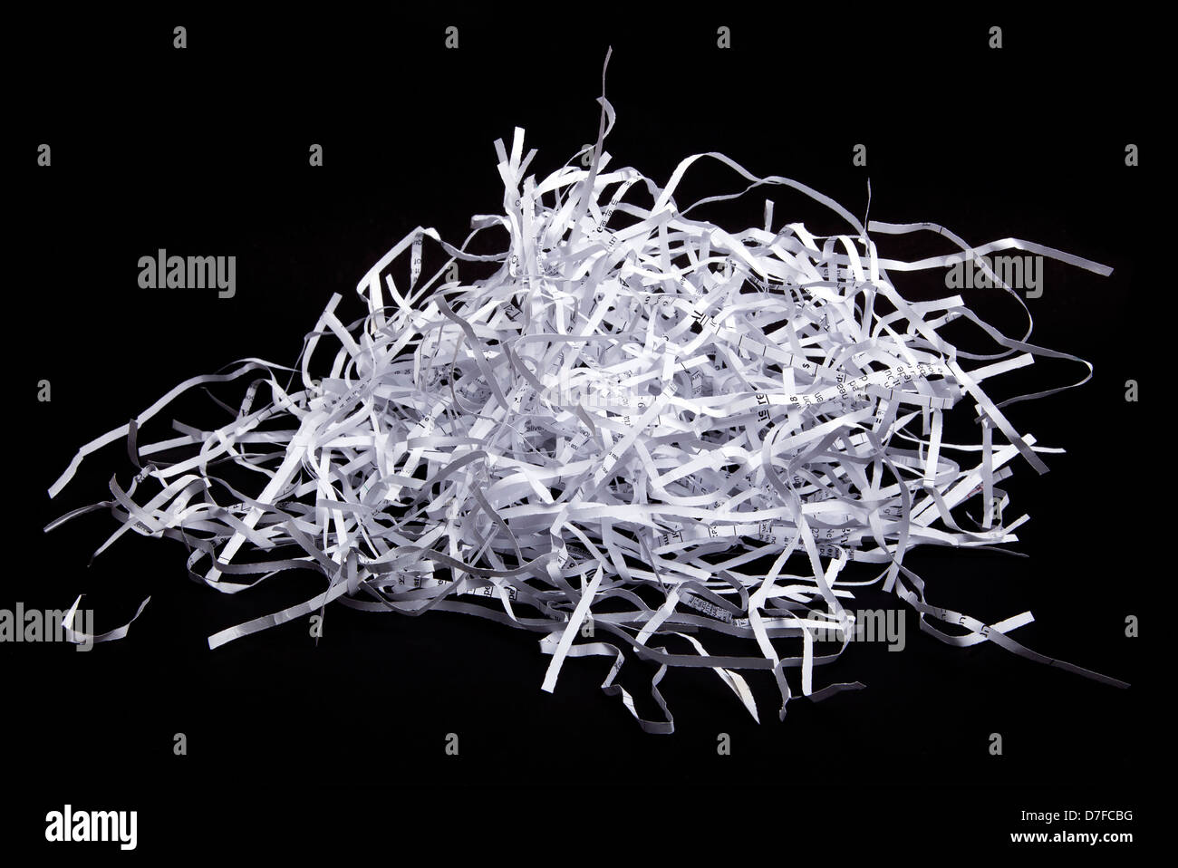 Shredded paper scraps isolated on black background. Stock Photo