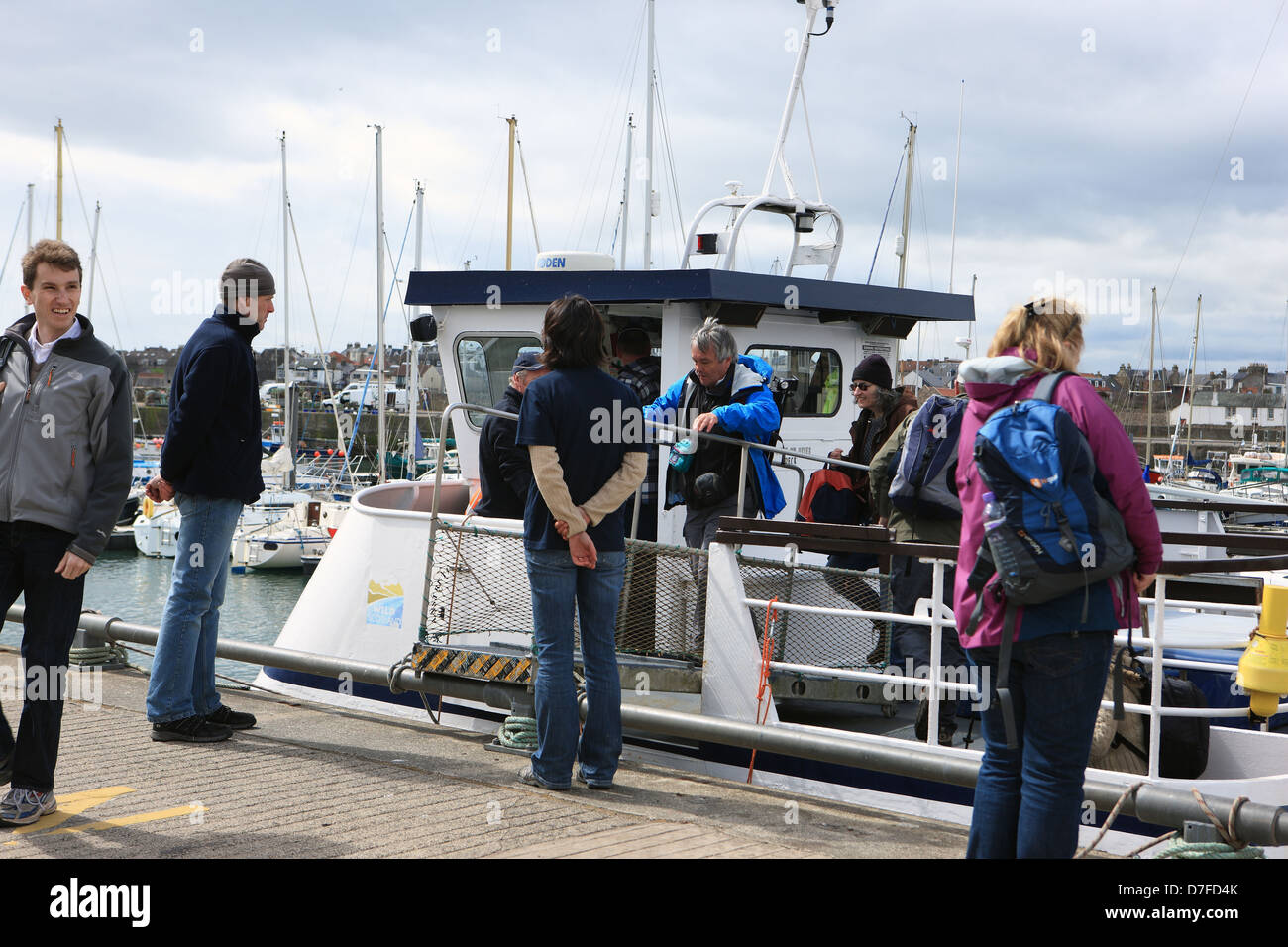 People disembarking from The May Princess at Anstruther in Fife Scotland following a day trip to the Isle of May Stock Photo