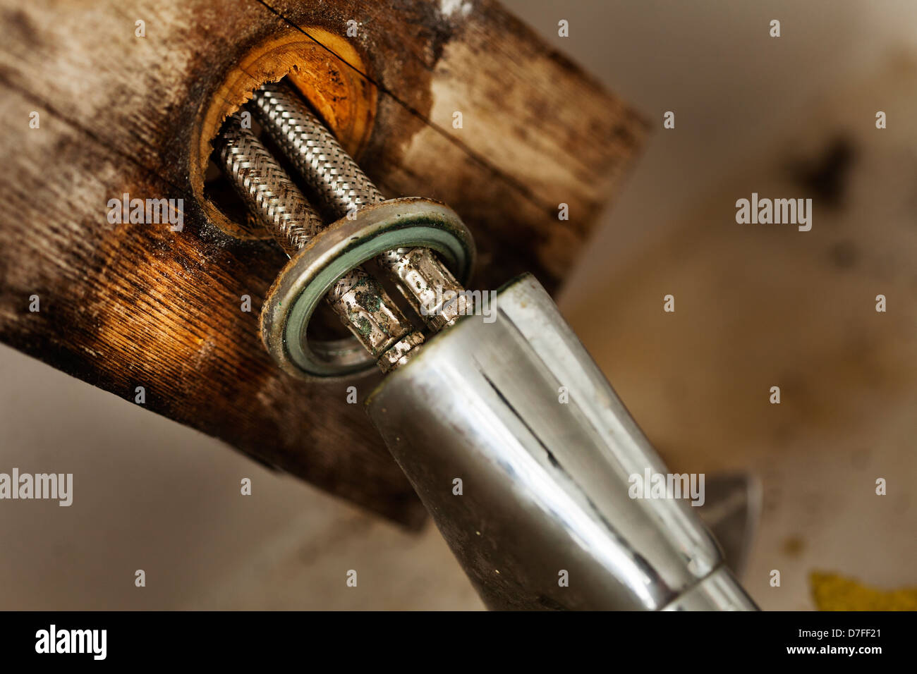 Macro view of the two pipes connected to a kitchen sink faucet. In the process of fixing a leak