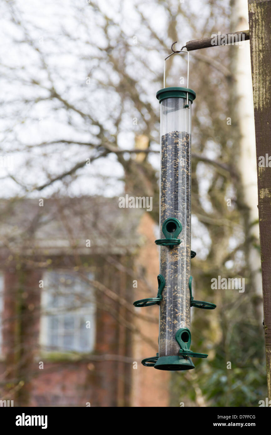 A Plastic Seed Feeder For Wild Birds Almost Full With Mixed Seeds