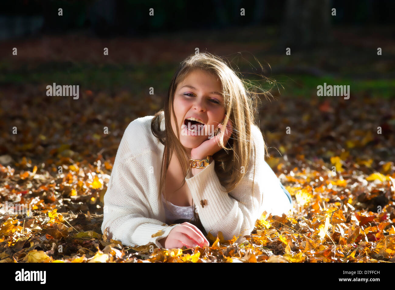 Teenage girl enjoying the autumn leaves Stock Photo