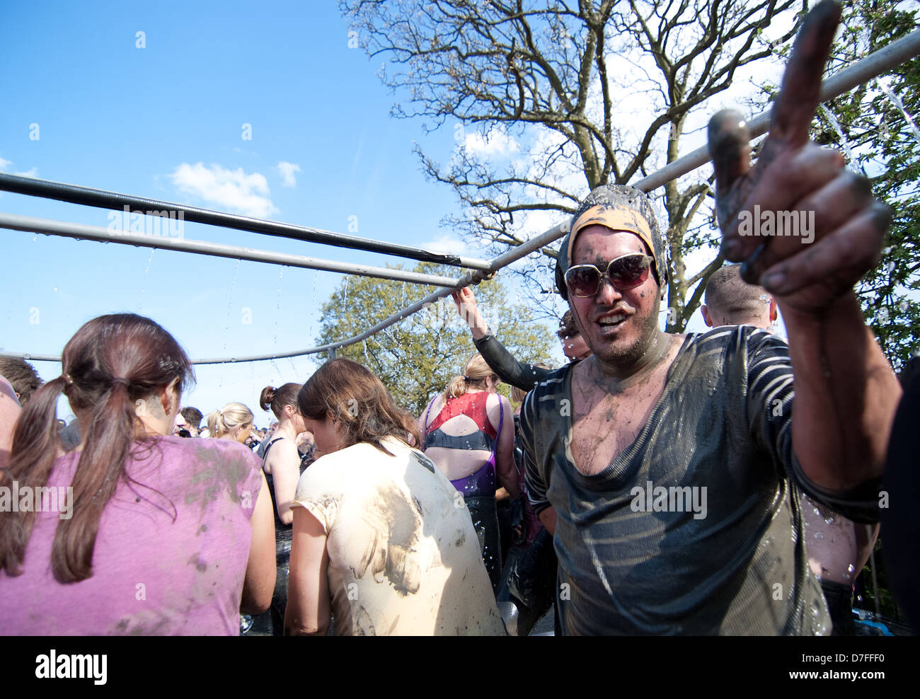 Man dressed as Elvis Presley cleans himself off after the 2013 Mud race. Stock Photo