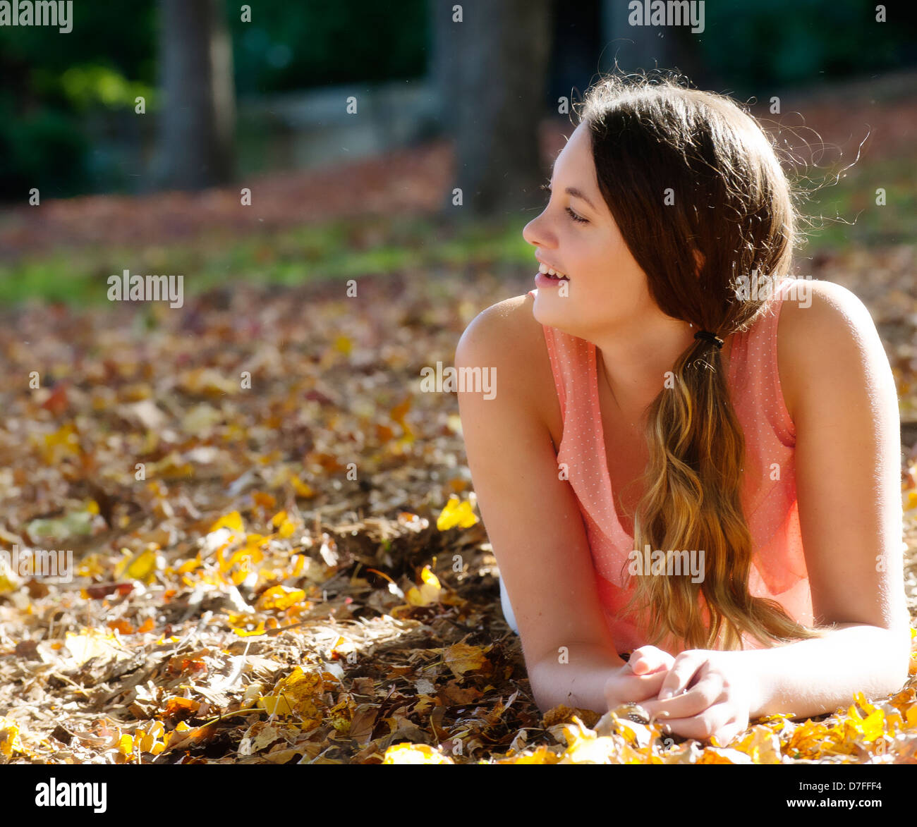 Teenage girl enjoying the autumn leaves Stock Photo