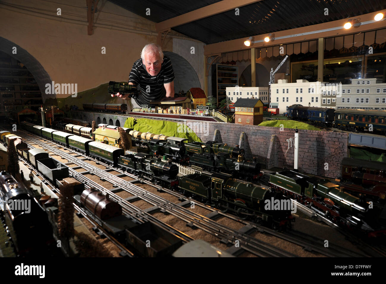 Brighton, Sussex, UK. Chris Littledale places a Hornby model train on