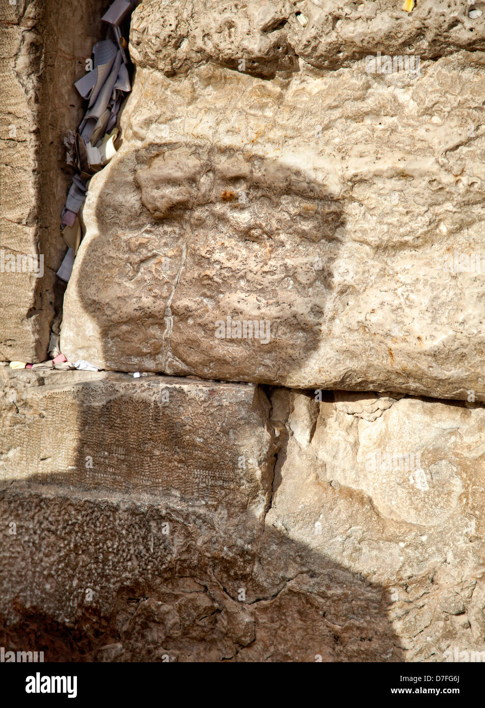 The shadow an orthodox Jewish man on sacred Wailing Wall in old city Jerusalem Israel. Letters wishes pleading to god can be Stock Photo