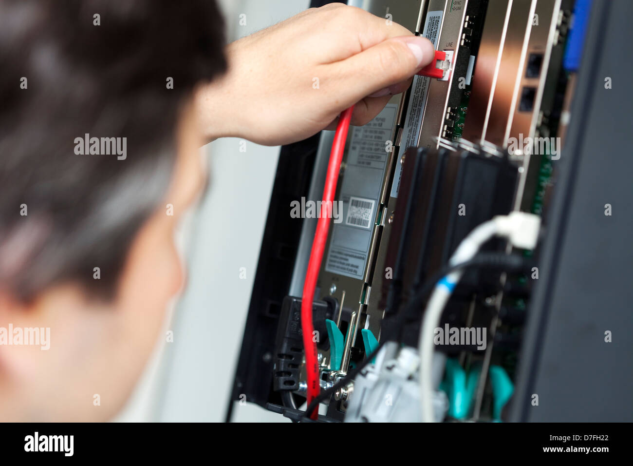 Shallow depth field close-up PBX (private branch exchange) which is phone exchange for particular business/office. technician Stock Photo