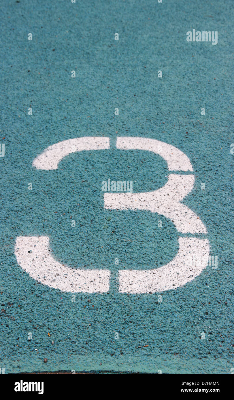 digit 3 on a blue athletics track Stock Photo