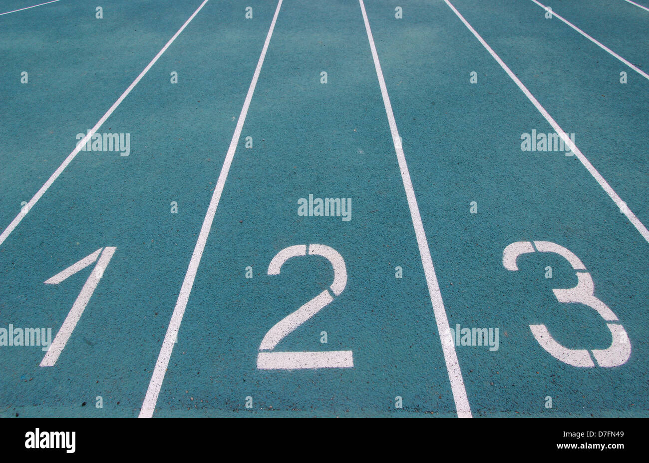 running racetrack with white lines on blue ground Stock Photo - Alamy