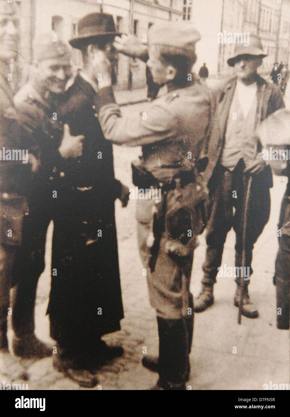 Nazis humiliate Polish Jew at Krakow ghetto in 1942 Stock Photo