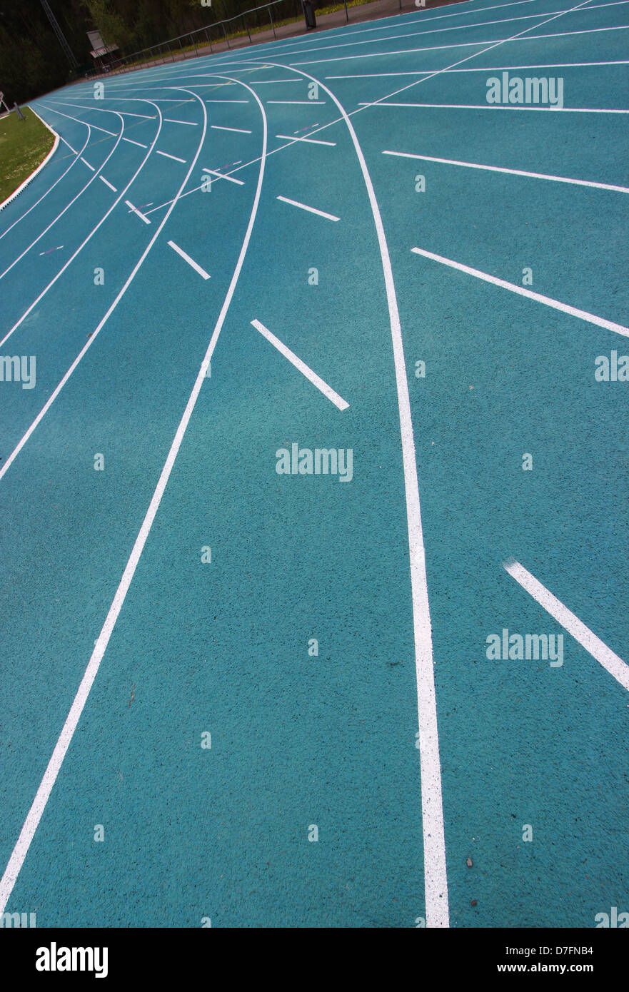 running racetrack with white lines on blue ground Stock Photo - Alamy