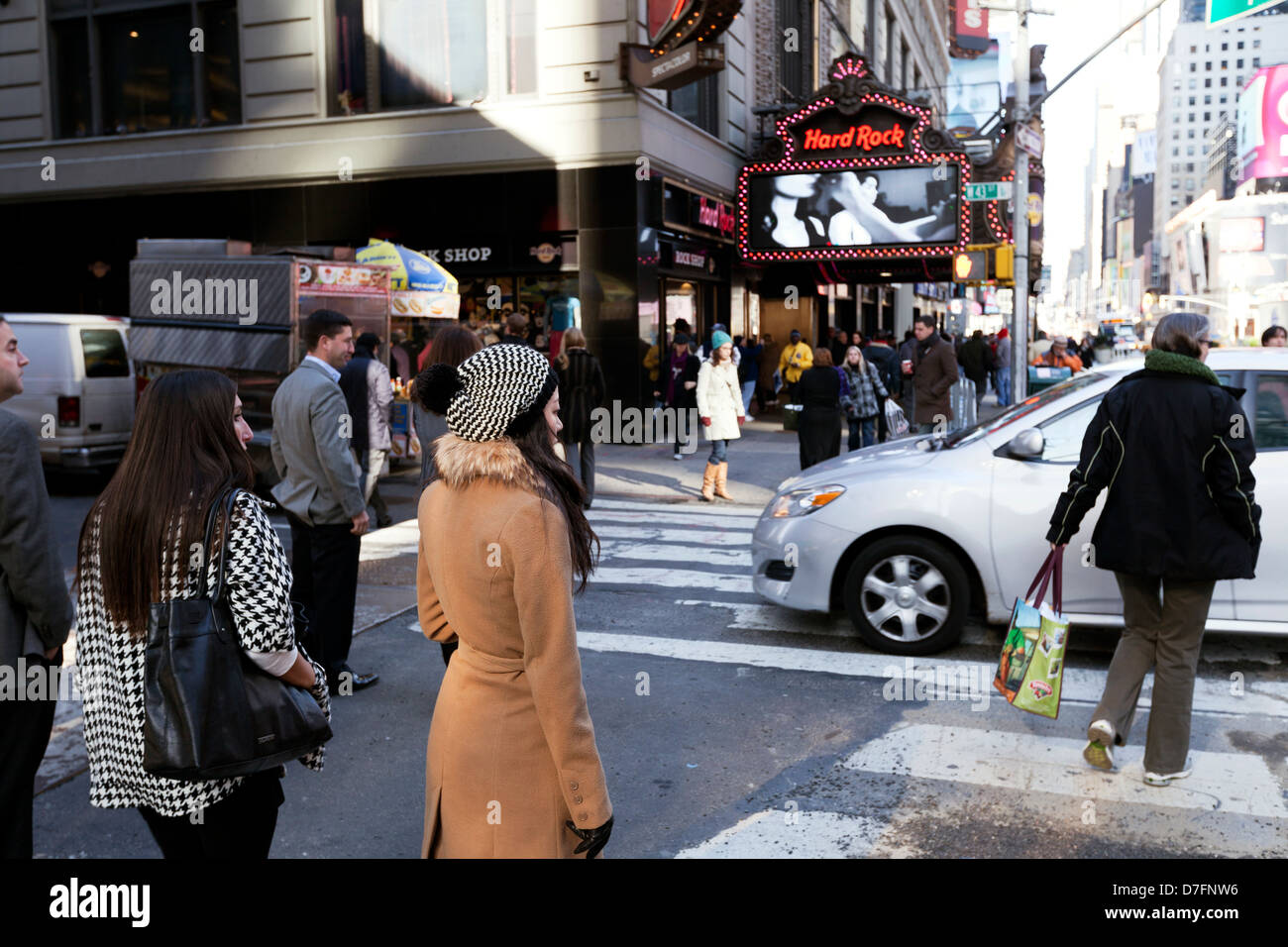 New-York USA - November 6th 2012: Pedestrians waiting on sidewalk while cars rush down street at Times Square in Manhattan at Stock Photo