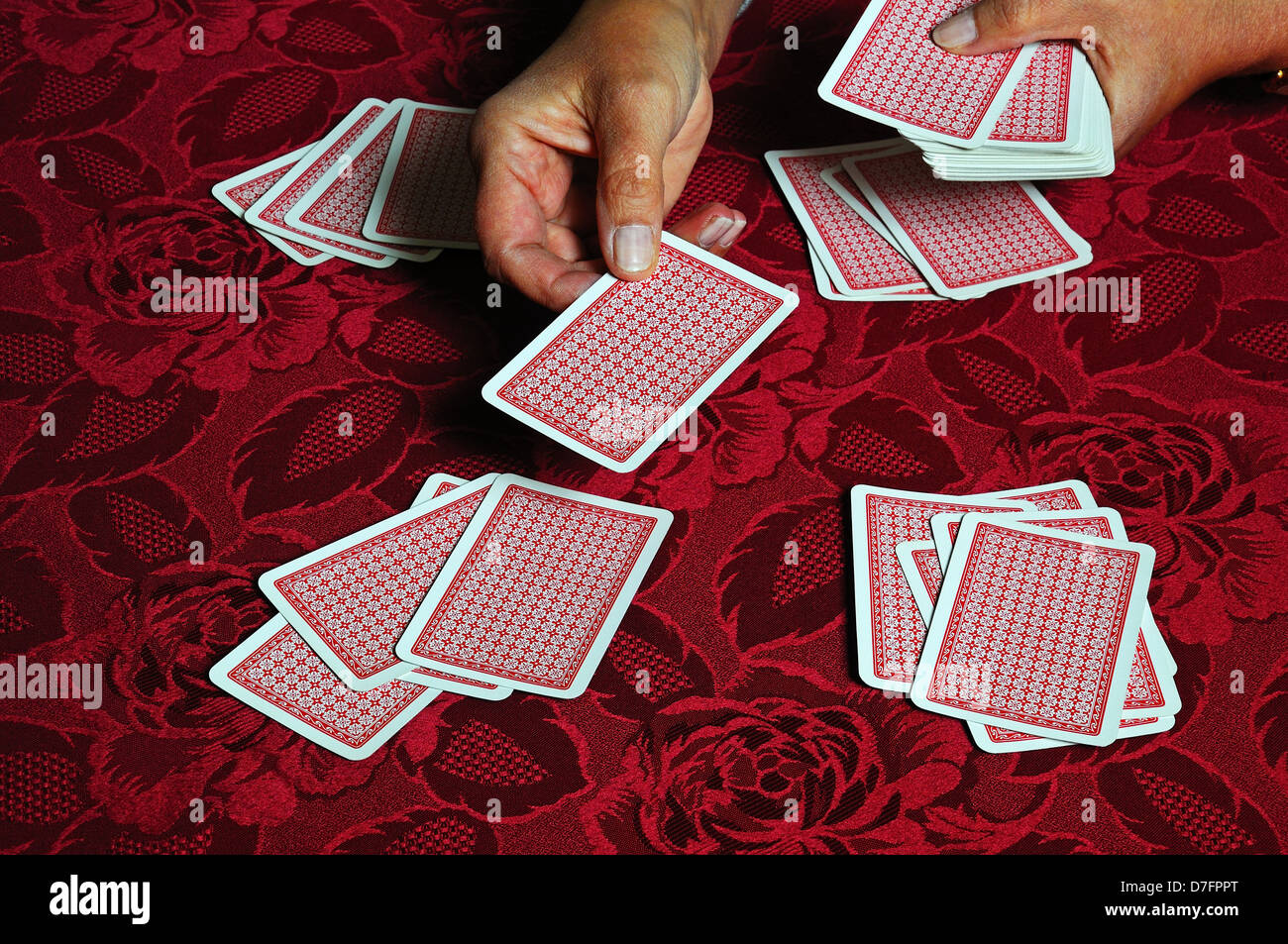 Woman dealing a pack of playing cards, England, UK, Western Europe
