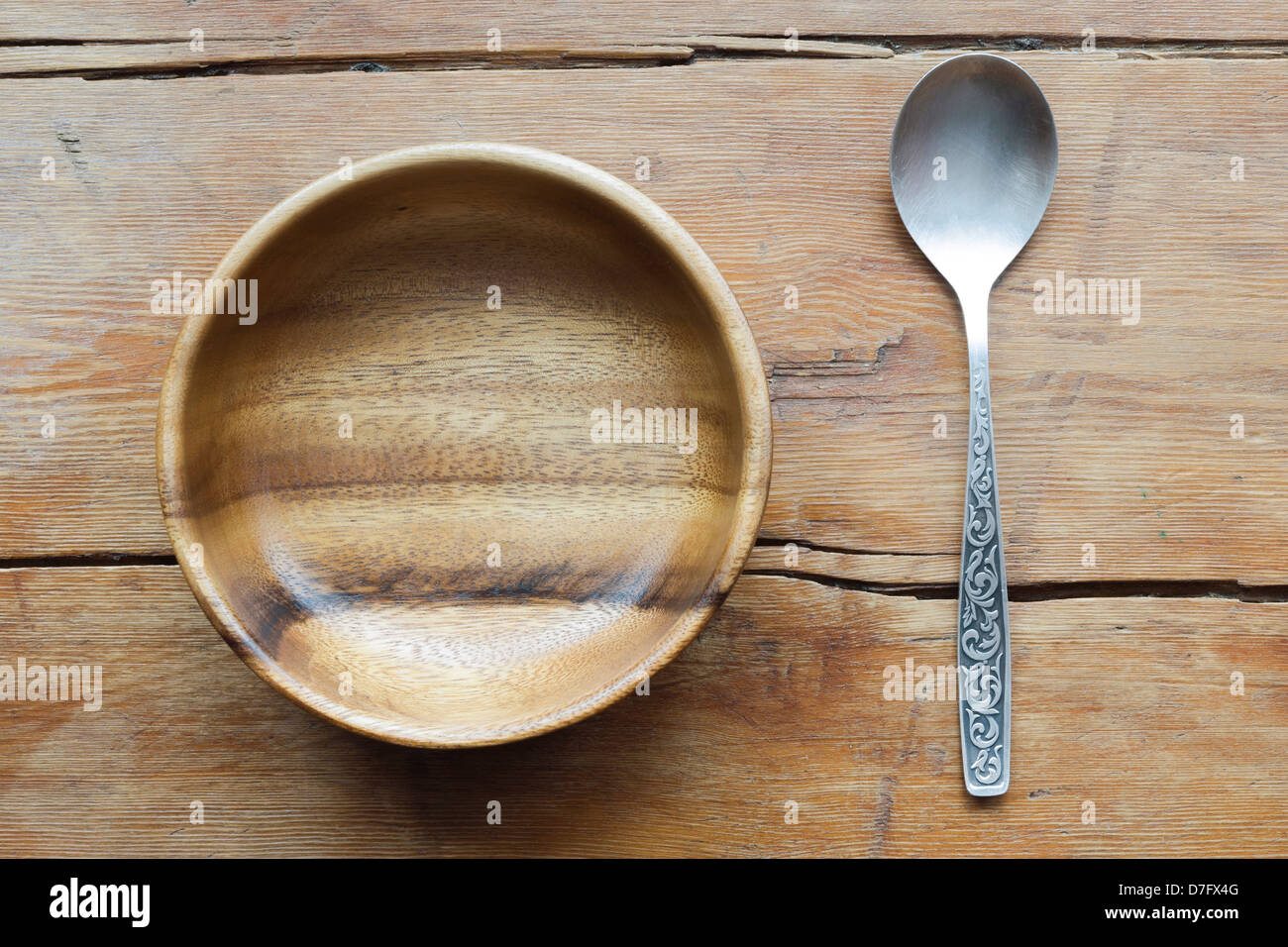 vintage wooden bowl and spoon on the weathered table surface Stock Photo
