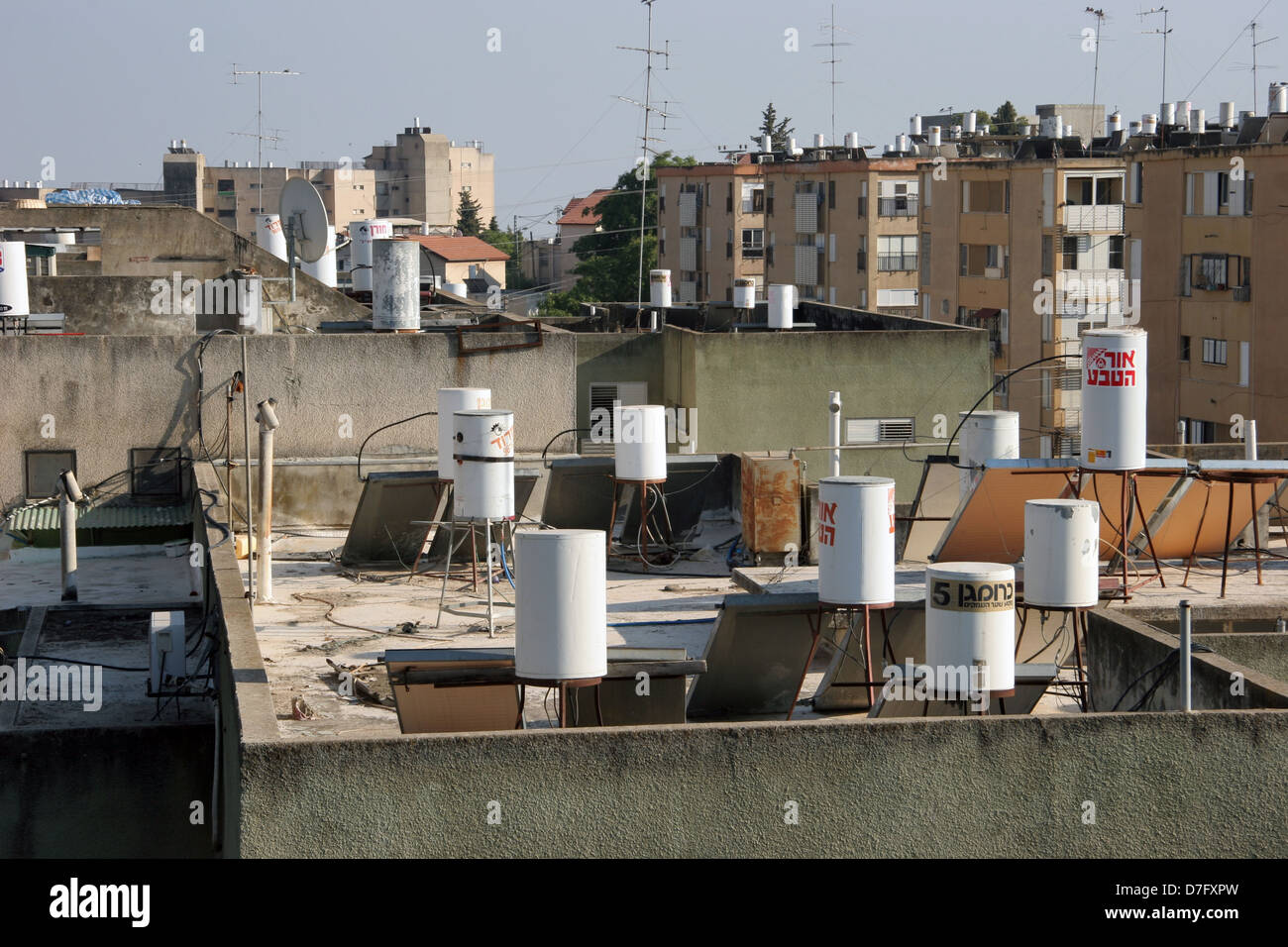 solar water heaters on roofs of houses in safed Stock Photo