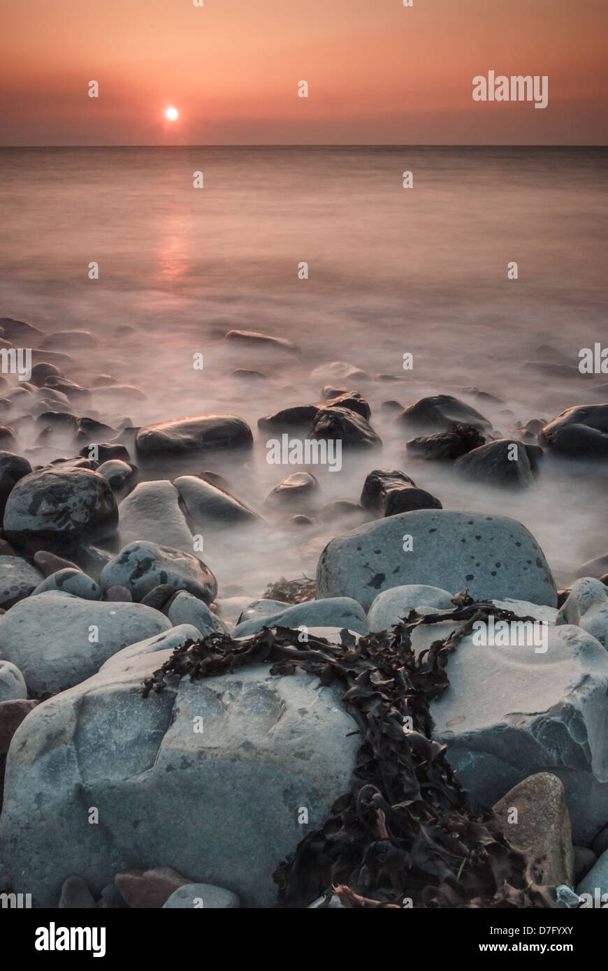 Sunset over rocky coastline hi-res stock photography and images - Alamy