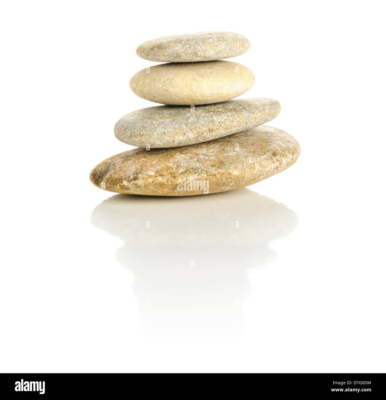 Pile of four pebble stones stacked in a pyramid isolated on a white reflective surface Stock Photo