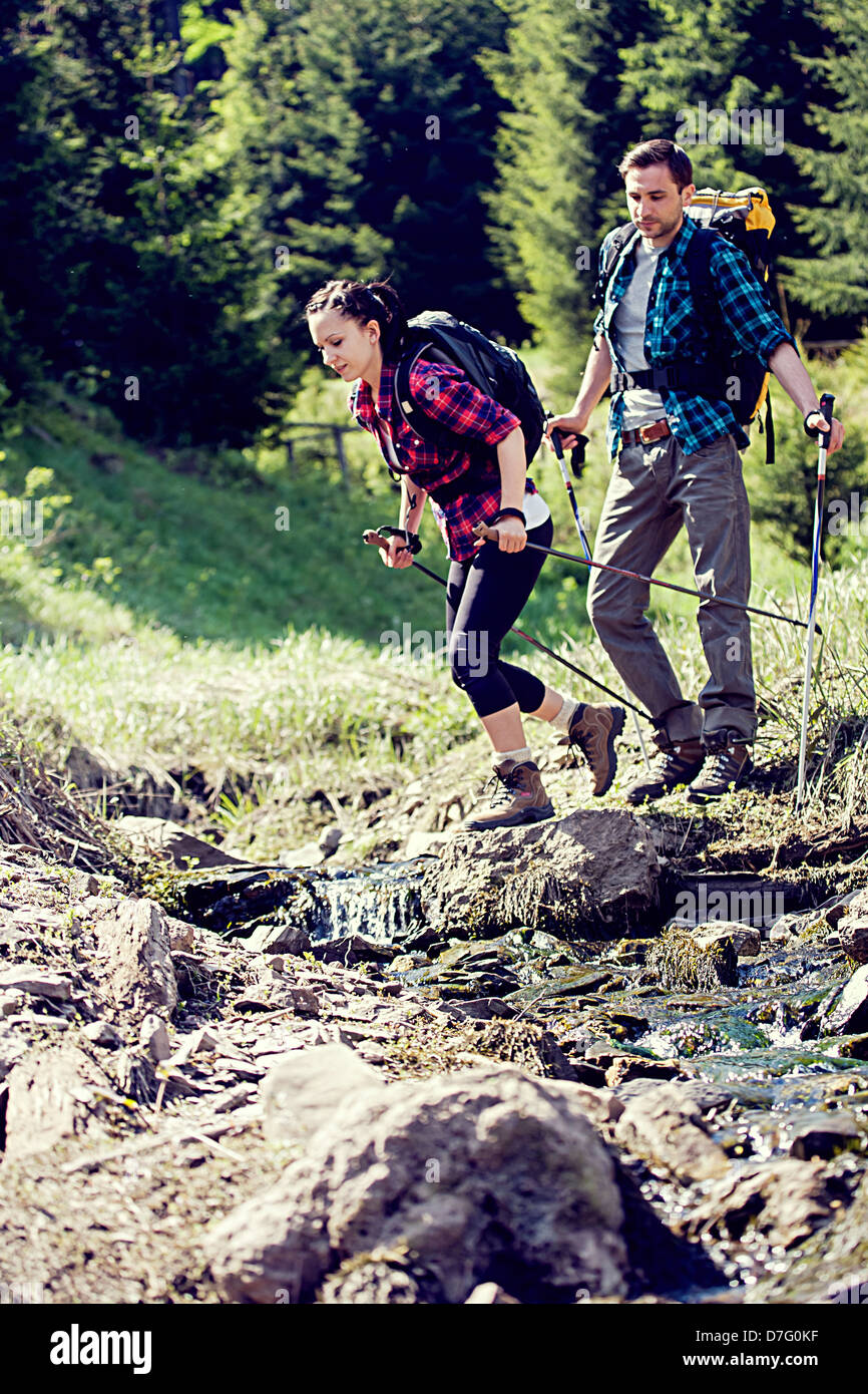 young couple hiking in the wild nature Stock Photo