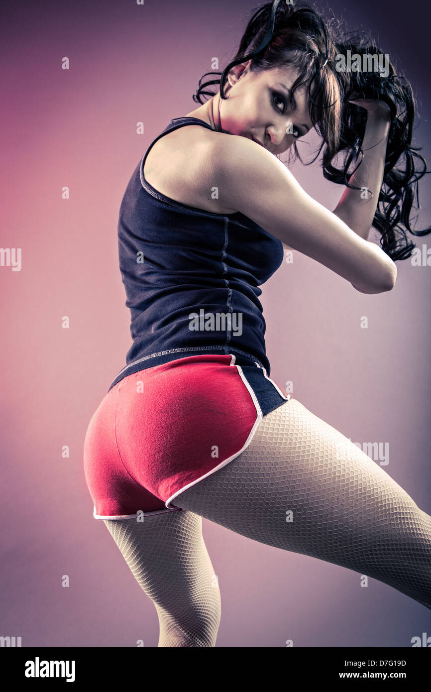 young woman in sport dress dancing in zumba or reggaeton or hiphop style Stock Photo