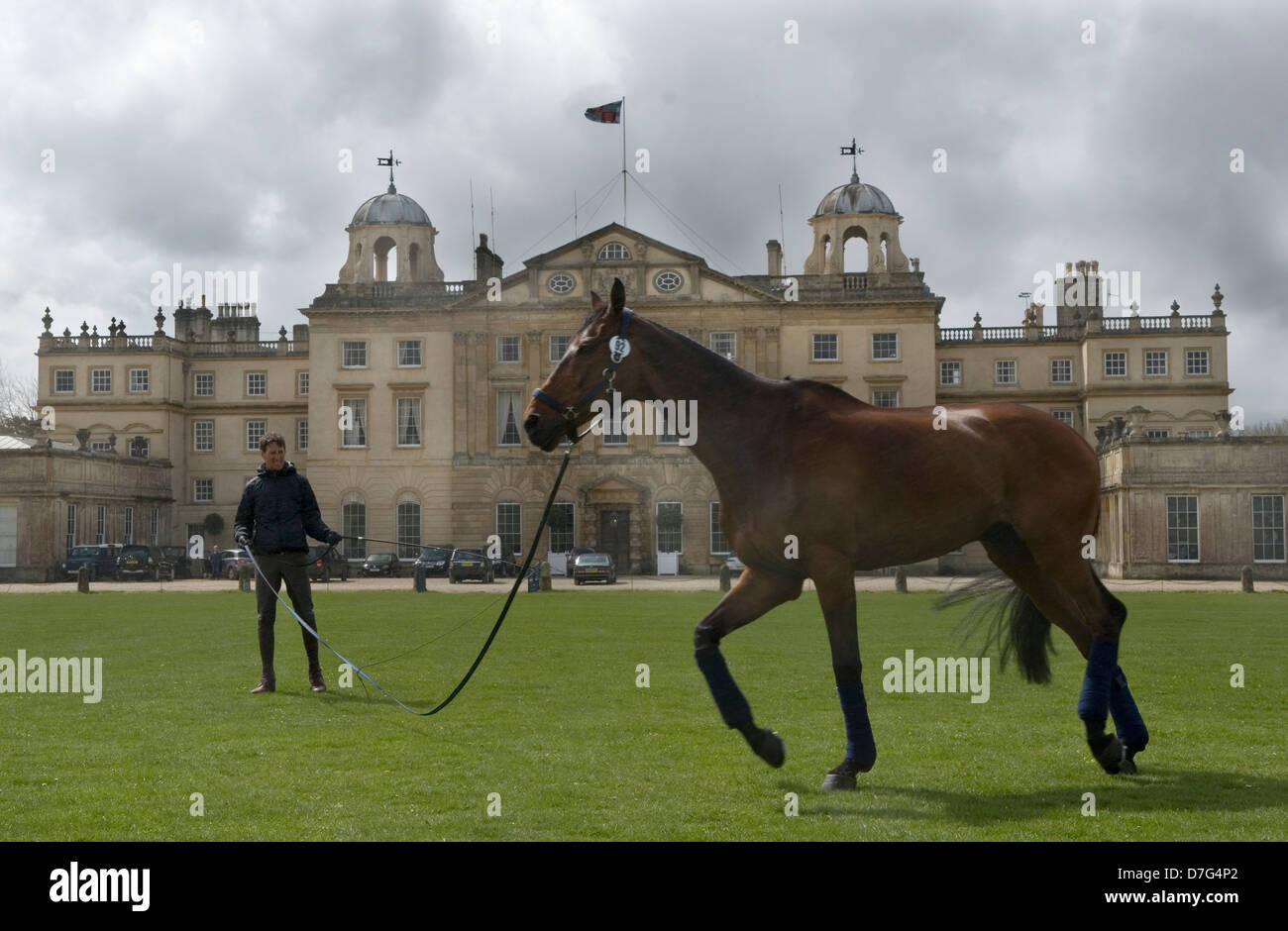 Badminton Horse Trials UK. Badminton House, competitor exercises his horse in front of the house. Badminton Estate, Gloucestershire England  4th May 2013 2010s HOMER SYKES Stock Photo