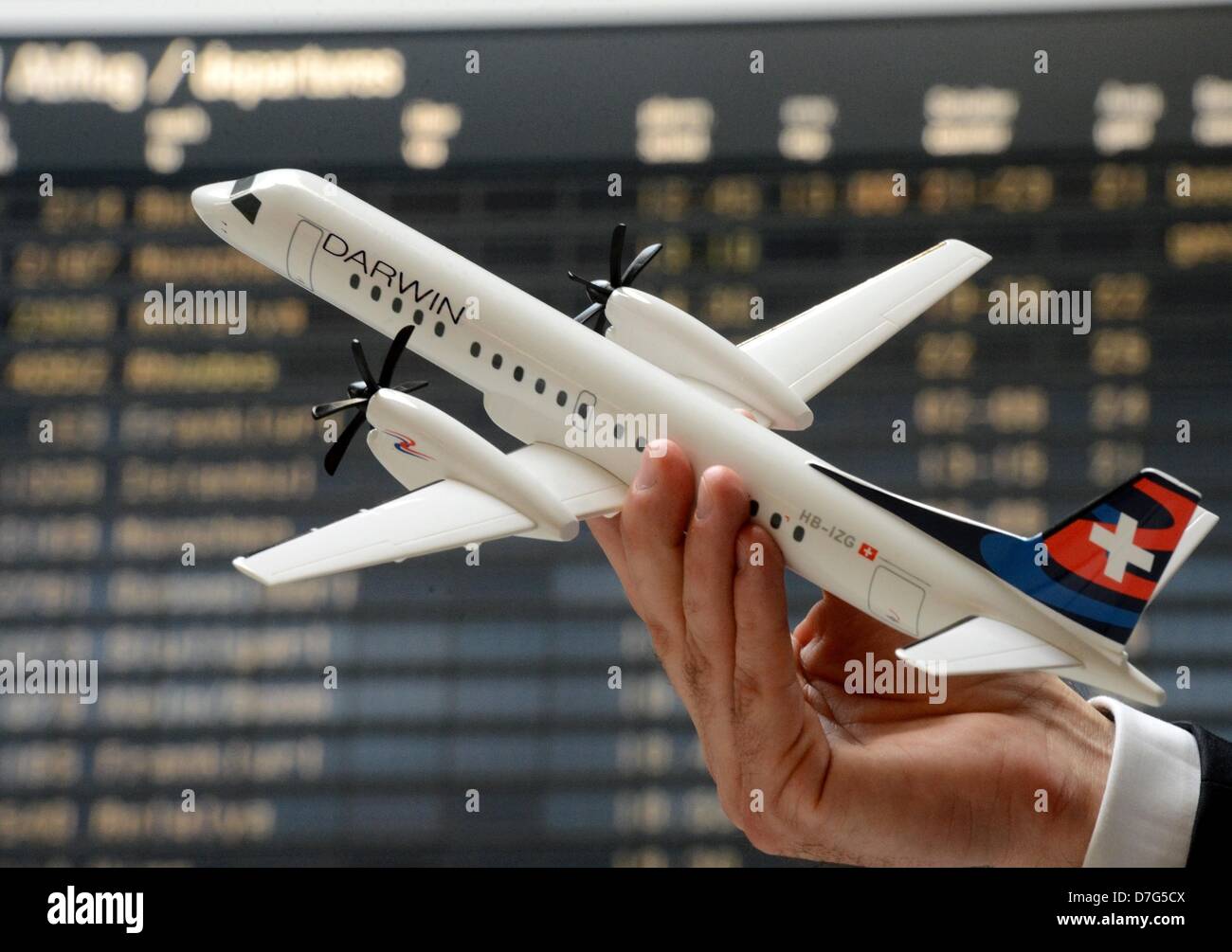 An employee of Darwin airlines based in Switzerland holds a model of a  turboprop airplane at the Leipzig/Halle Airport in Leipzig, Germany, 07 May  2013. Darwin will start flying to Paris and