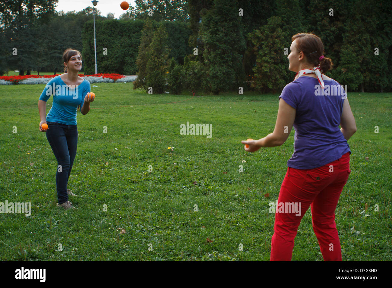 Two girls practice juggling with balls Stock Photo Alamy