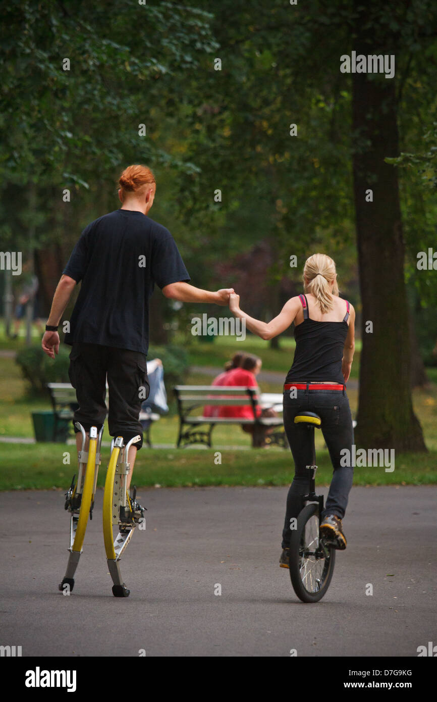 Young people wearing jumping stilts exercising in the park Stock Photo Alamy