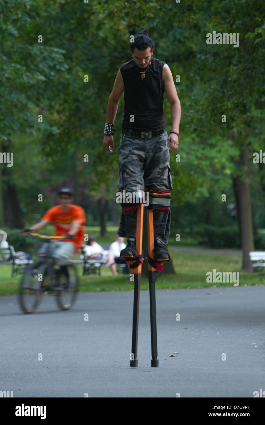 Man wearing stilts exercising in the park Stock Photo Alamy