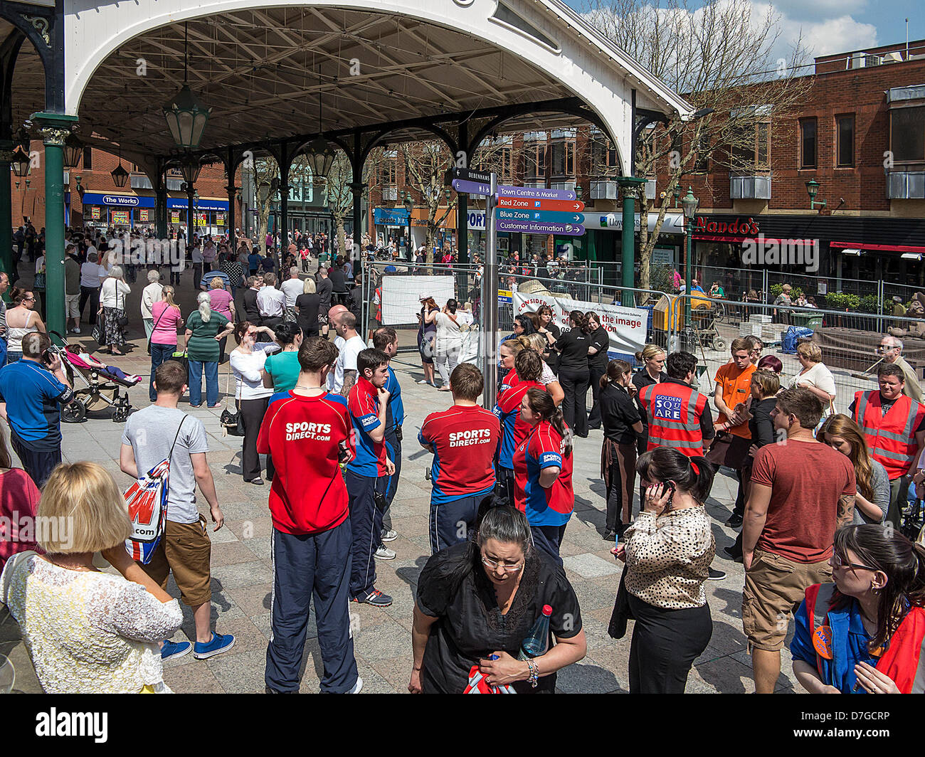 Warrington, UK. 7th May 2013. Warrington's 'Golden Square' shopping centre and all the shops around it was closed this morning due to a suspected bomb scare. All staff and customers were waiting in the 'Old Fish Market' outside. Credit:  John Hopkins / Alamy Live News Stock Photo