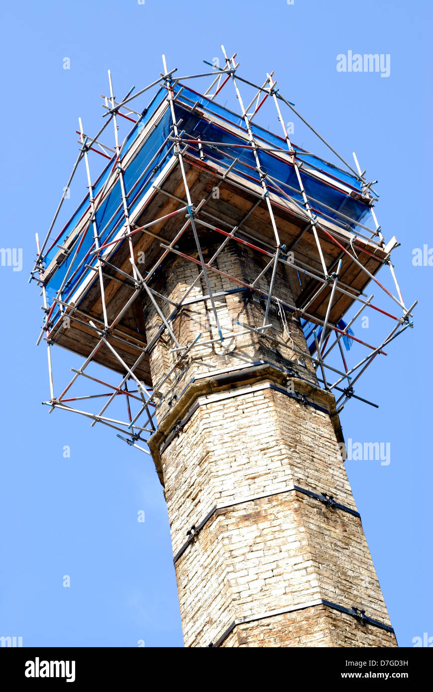 A chimney in Huddersfield West Yorkshire with scaffolding at the top. Stock Photo