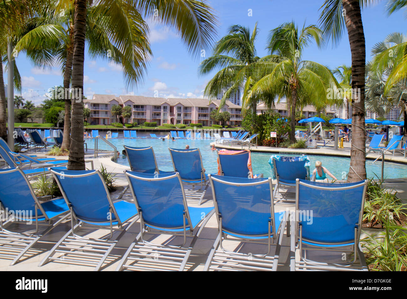 Hollywood Florida,water,Crowne Plaza Hollywood Beach,hotel,swimming pool area,palm trees,lounge chairs,FL120929120 Stock Photo