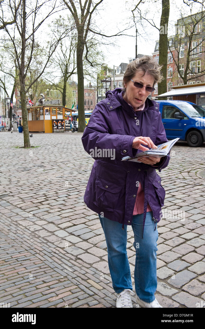 Tourist consulting a guide book. Stock Photo