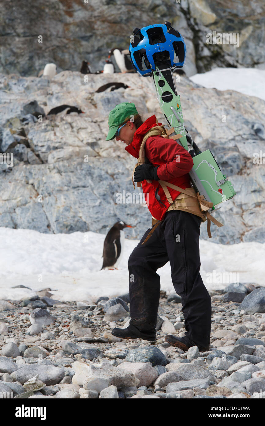 Heather Lynch carrying a Google Street View camera, Cuverville Island, Antarctica. Stock Photo