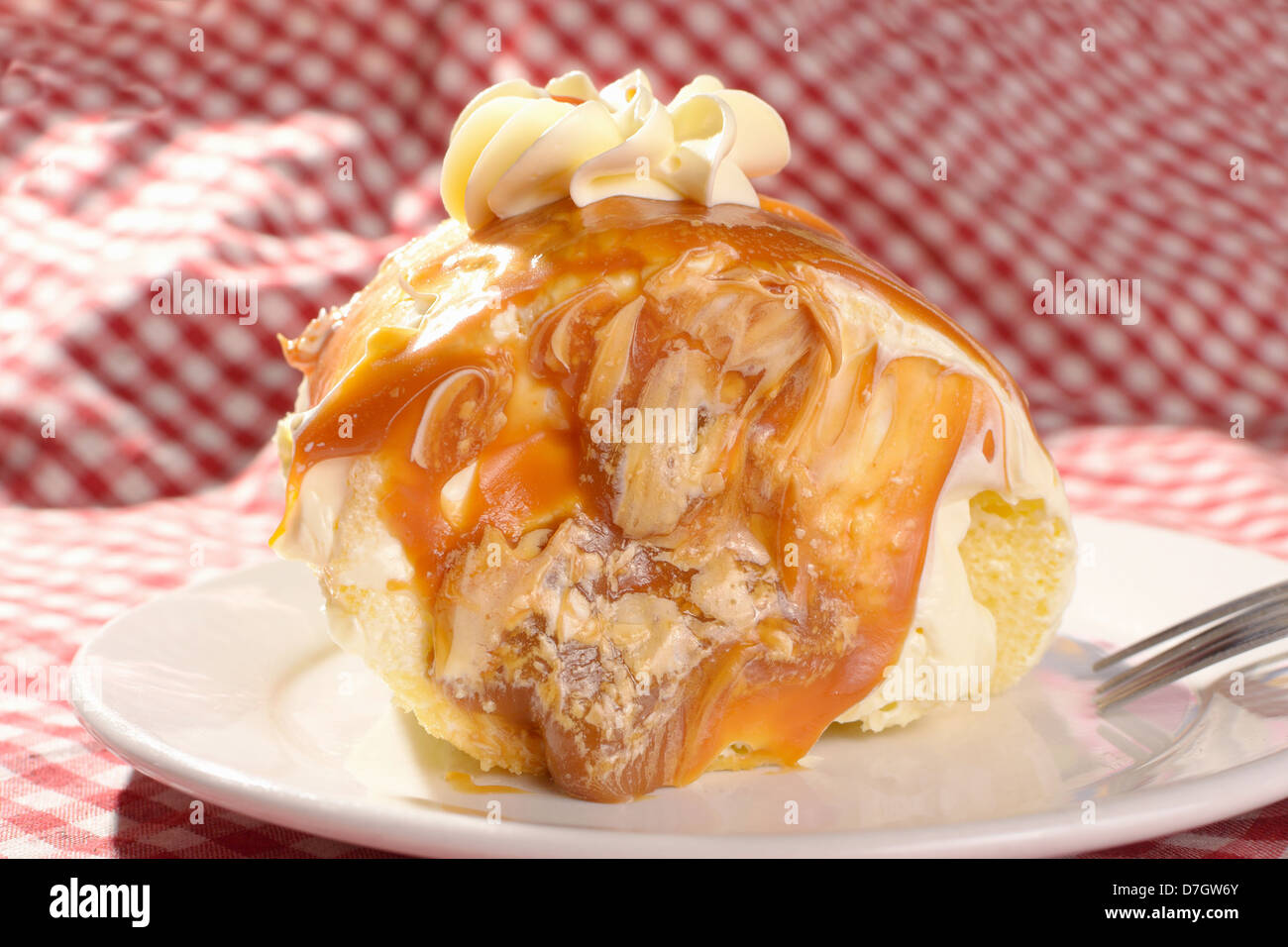 mouth-watering slice of dulce de leche roll with vanilla buttercream icing on top and caramel filling. Stock Photo