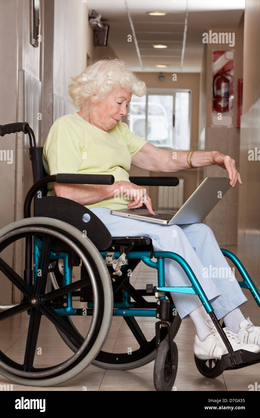 Woman on Wheelchair Using Laptop Stock Photo - Alamy